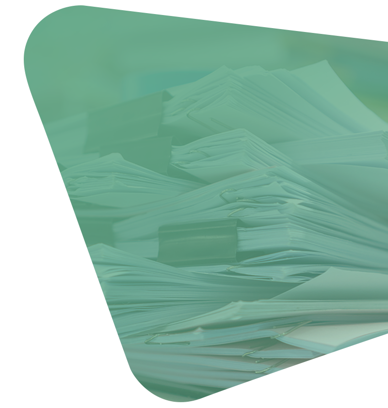 A messy stack of paperwork held together by binder clips, viewed through a soft, green, geometric overlay.