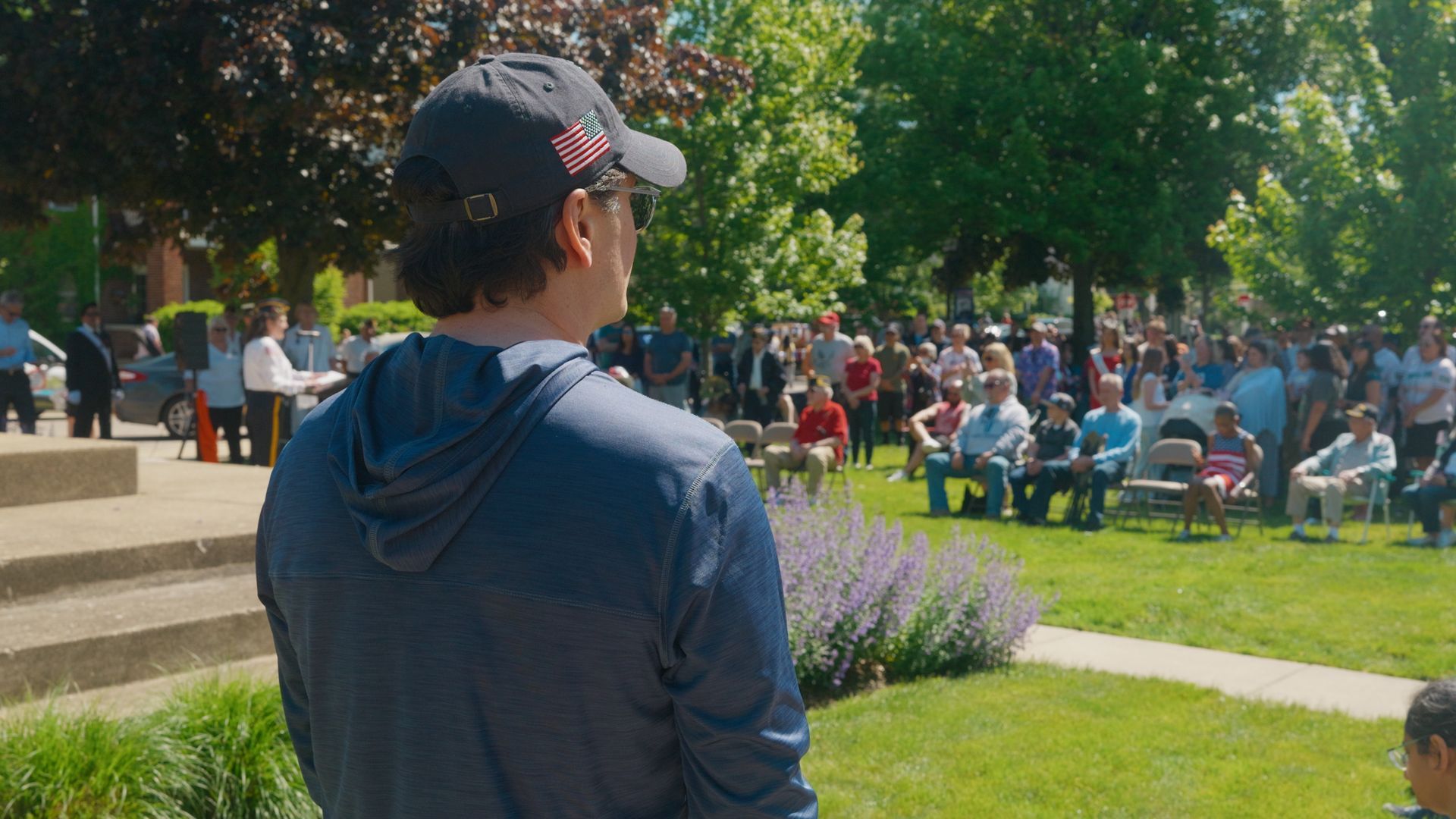 Michael Sawicky in the memorial day parade in Farmington Hills in a navy hoodie and cap 