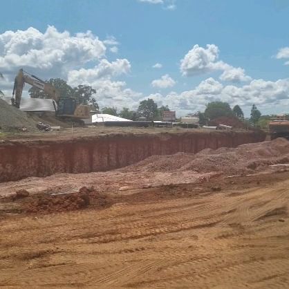A large pile of dirt is sitting on top of a dirt field.