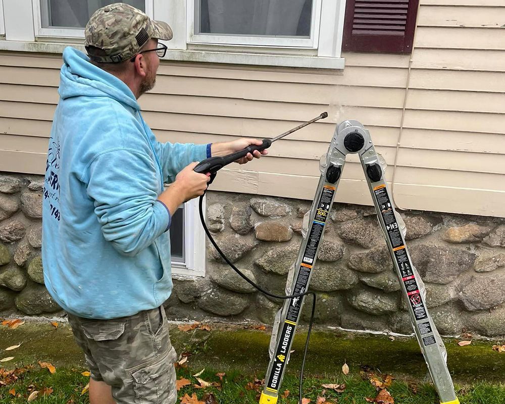 Man Power Washing the House Siding — Worcester, MA — Collazo Home Improvements & Property Maintenance LLC Man Power Washing the House Siding — Worcester, MA — Collazo Home Improvements & Property Maintenance LLC