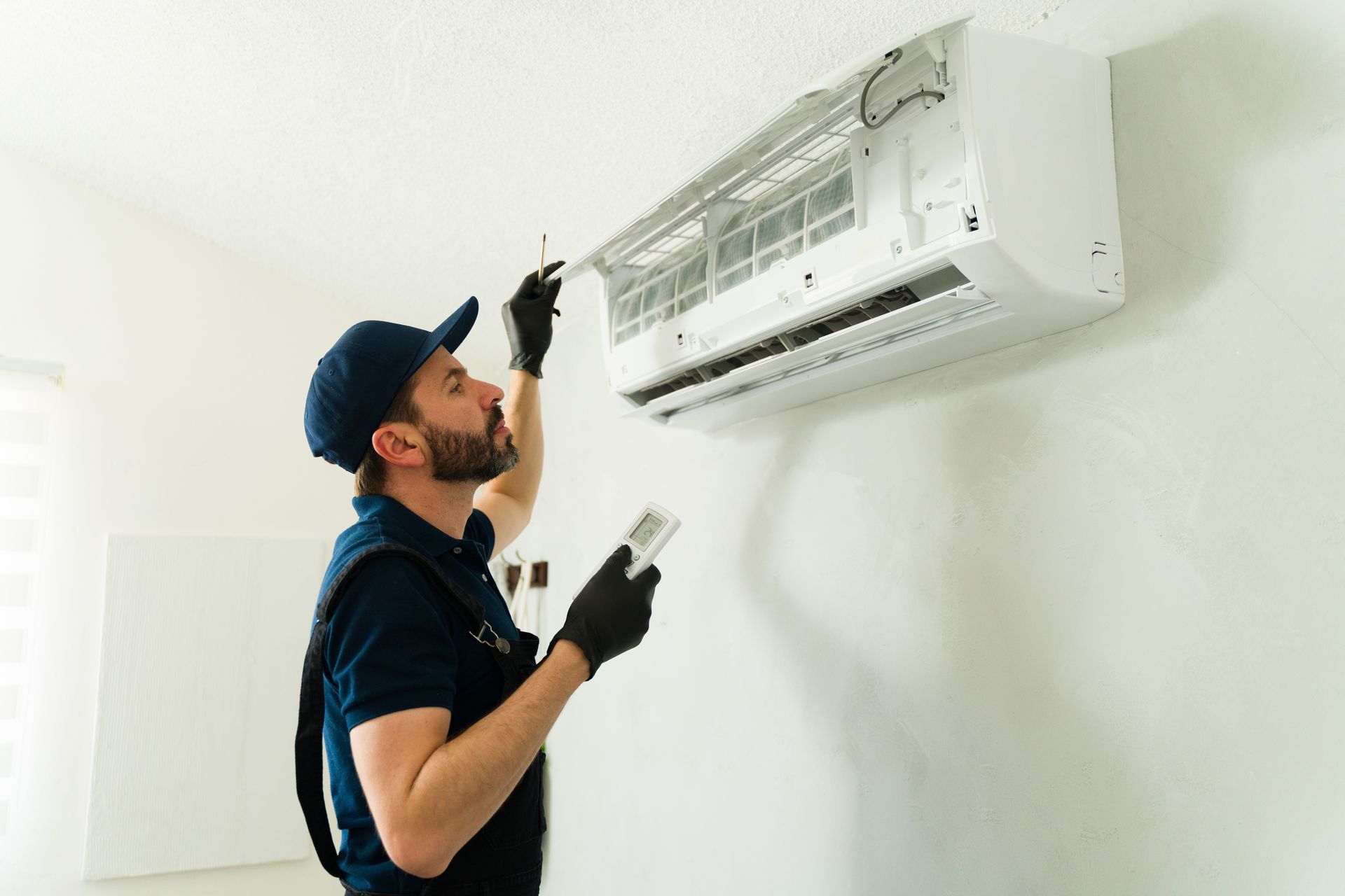 A man is inspecting an AC.
