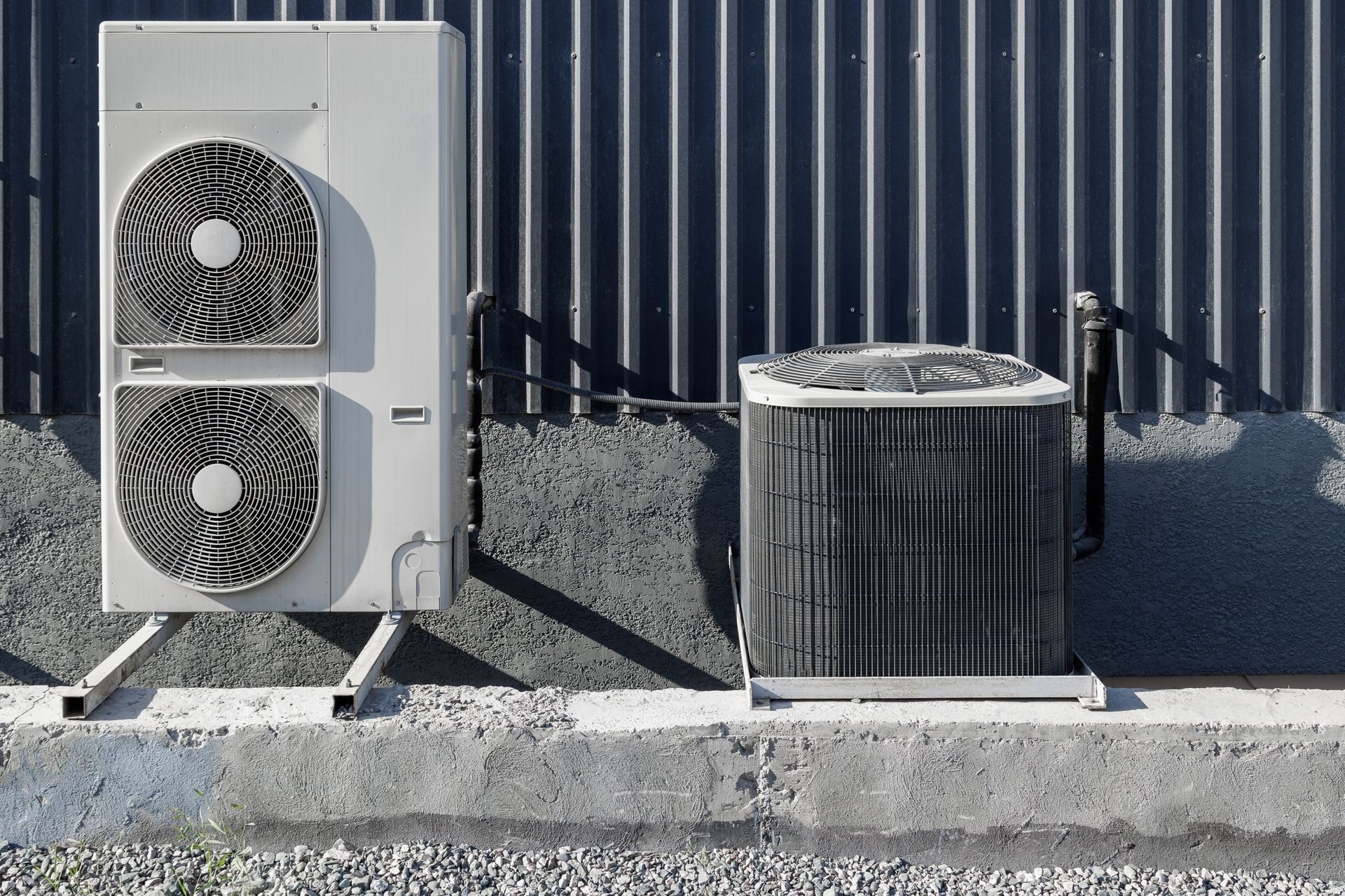 Air conditioning units are installed outside buildings.