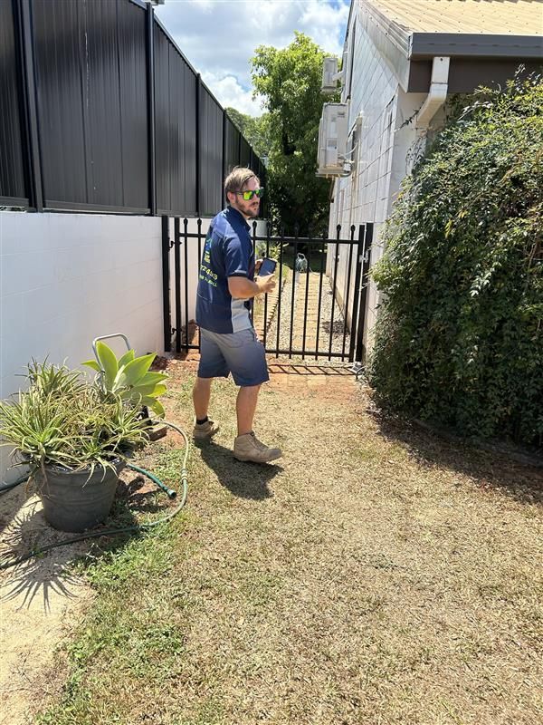 Man Standing At Backyard Fence — Youfi Fixit Handyman Services in Edmonton, QLD
