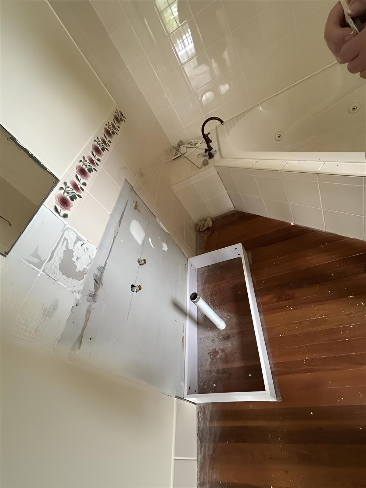 Bathroom With a Wooden Floor and White Tiles — Youfi Fixit Handyman Services in Edmonton, QLD