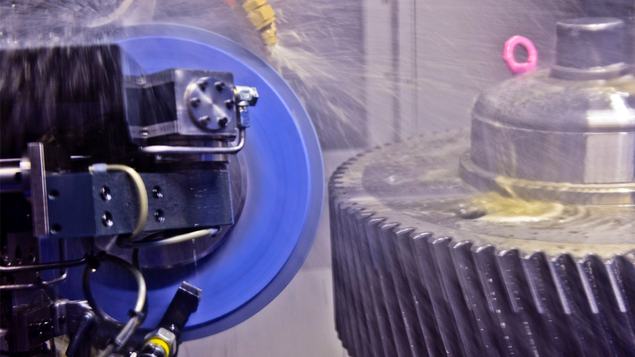 A machine is cutting a piece of metal in a factory.