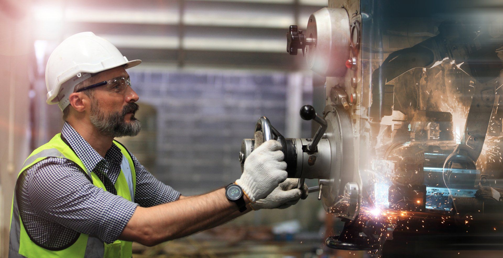 A man is working on a machine in a factory.