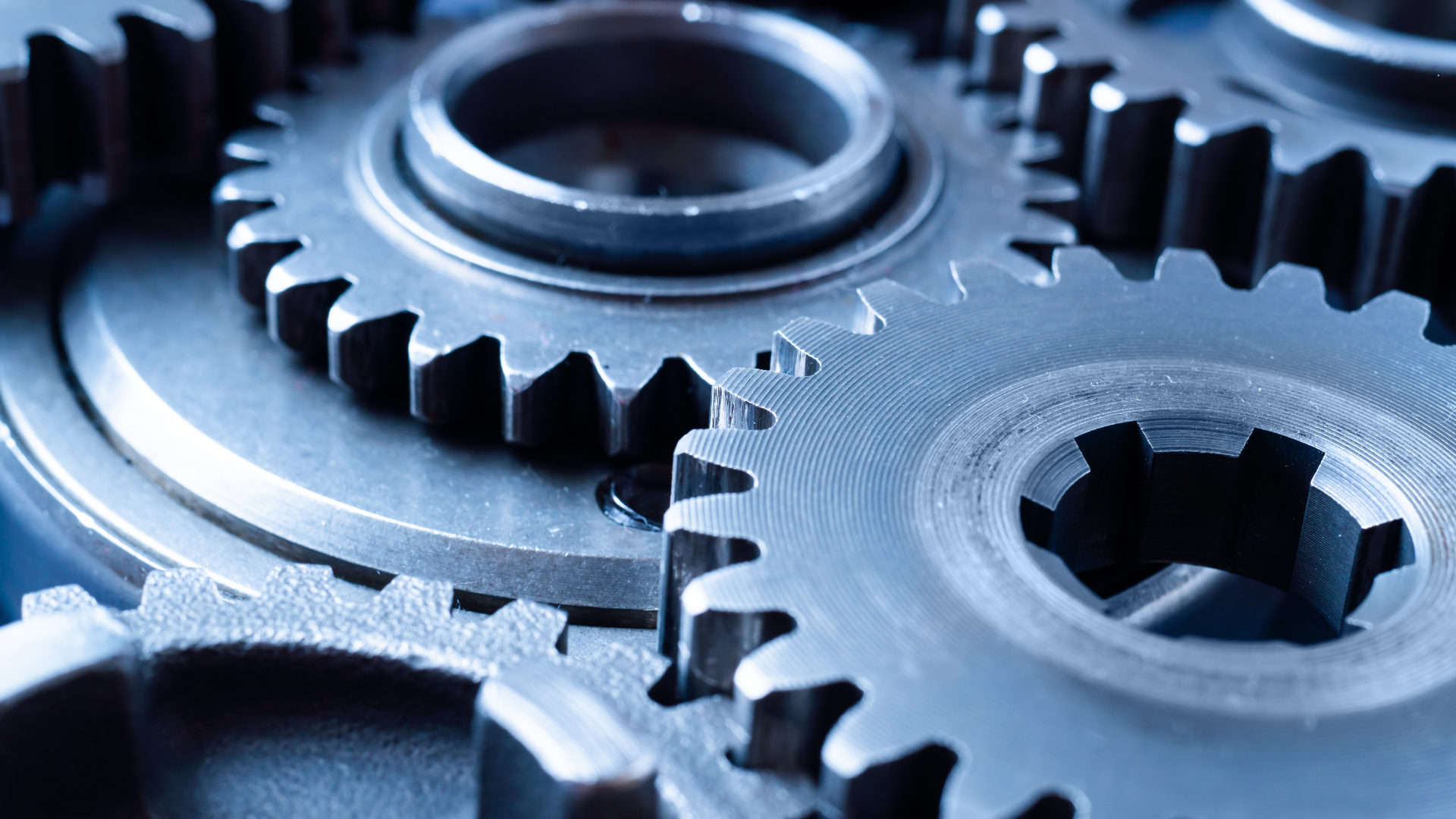 A close up of a group of gears on a blue surface.