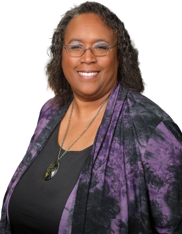 A woman wearing glasses and a purple jacket smiles for the camera