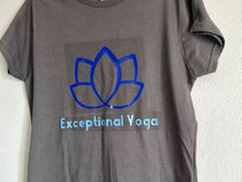 A grey t-shirt with exceptional yoga written on it