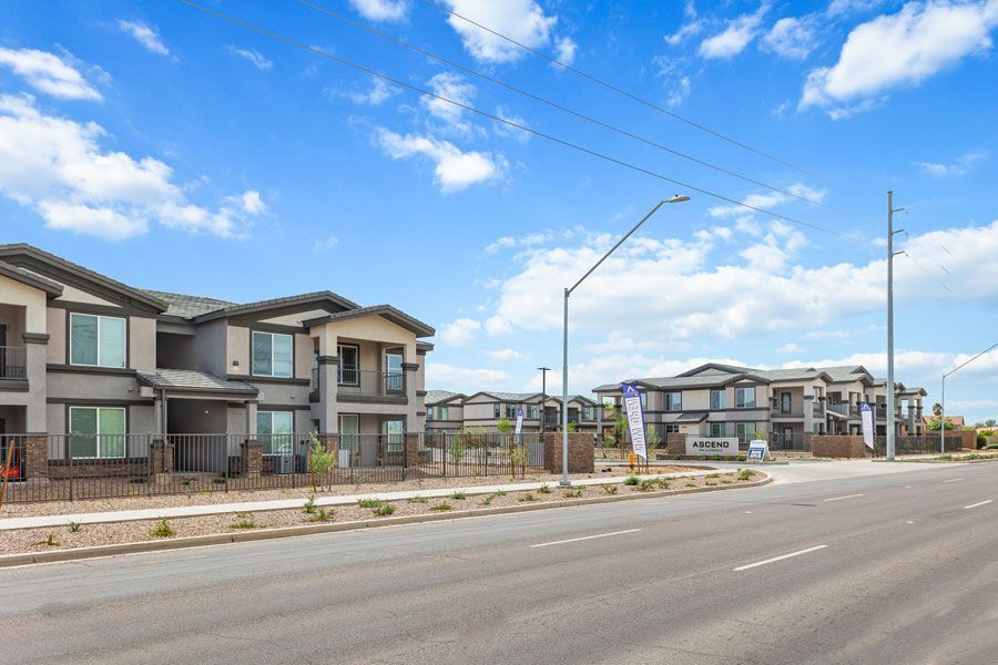 A row of houses sitting next to each other on the side of a road.