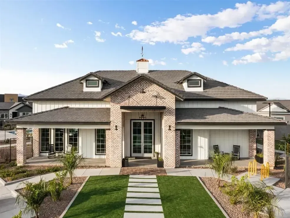 A large house with a walkway leading to the front door