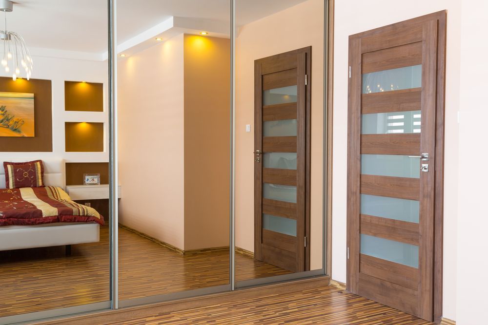 A Bedroom With Sliding Glass Doors and a Bed — Glass 24/7 In Taree, NSW