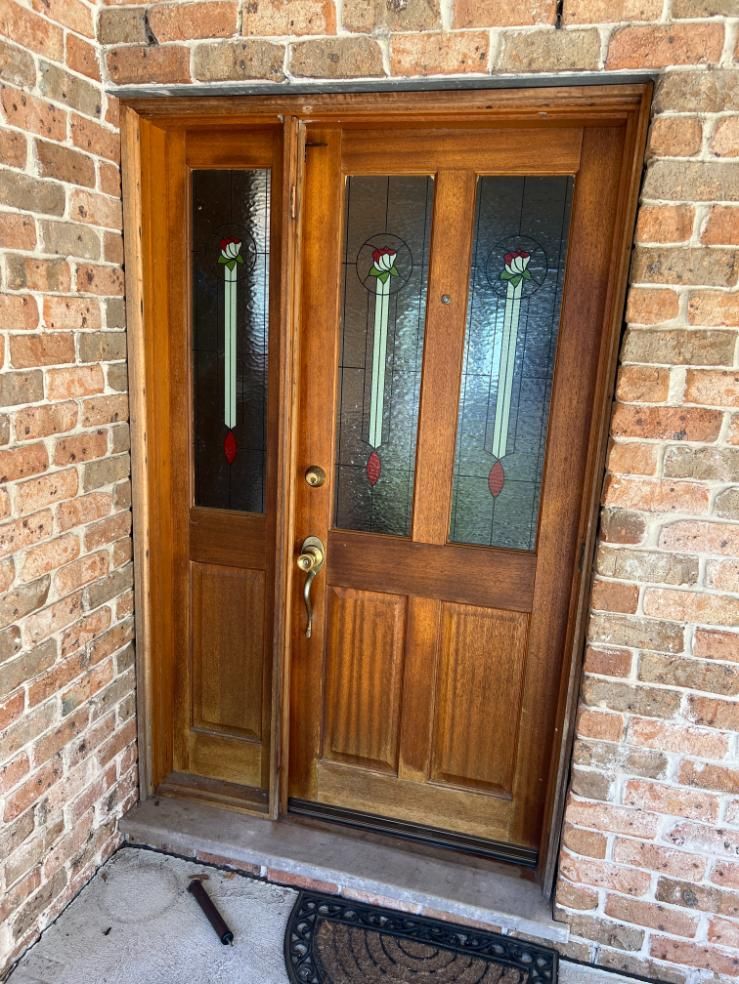 A Wooden Door With A Stained Glass Window Is On A Brick Wall — Glass 24/7 In Taree, NSW