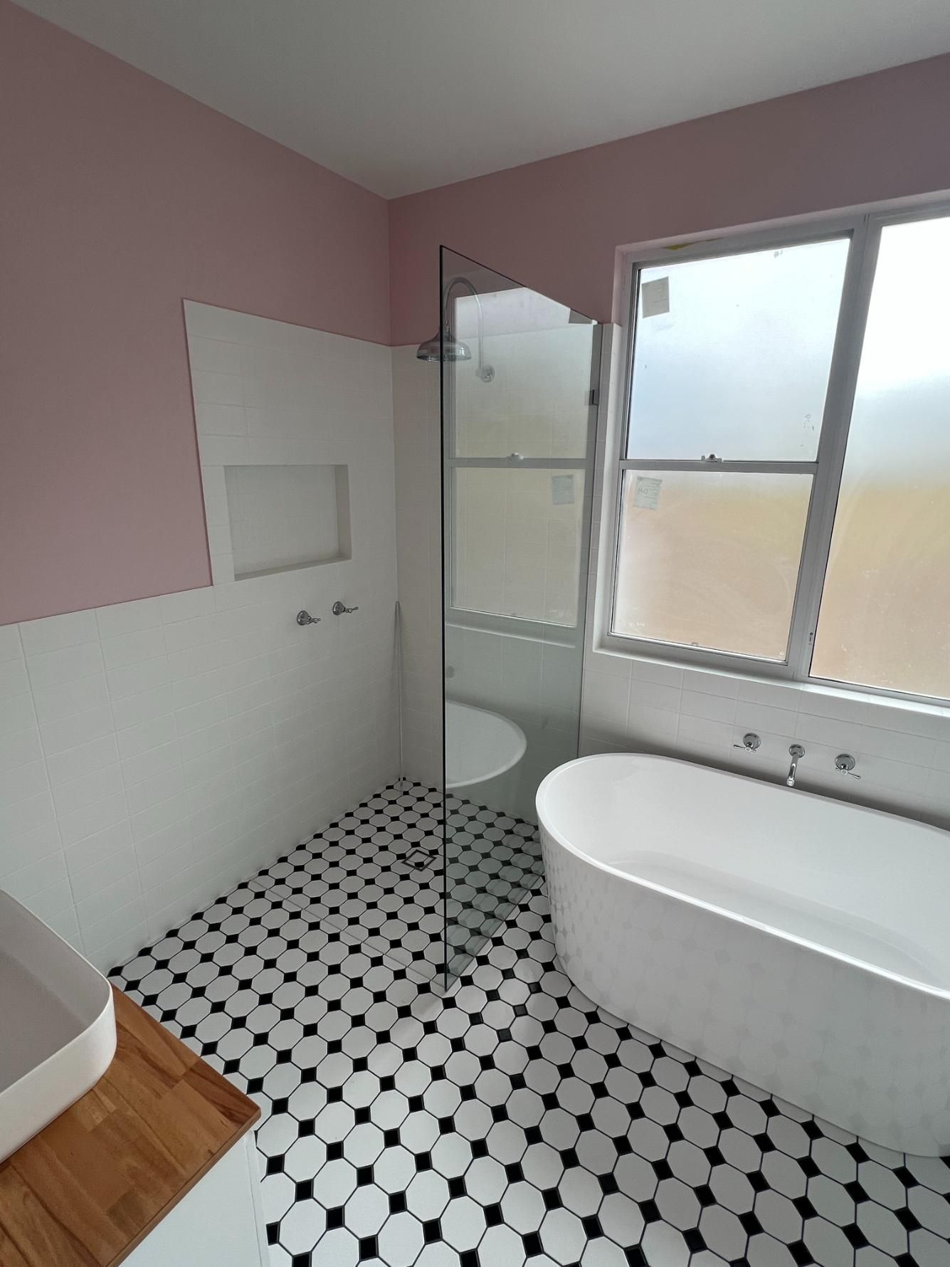 A Bathroom With A Bathtub, Sink, Shower And Window — Glass 24/7 In Forster, NSW