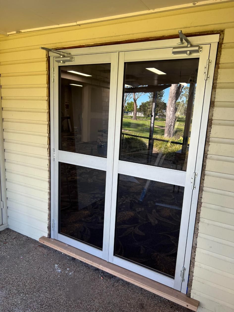 A Pair Of Sliding Glass Doors On The Side Of A Building — Glass 24/7 In Pacific Palms, NSW