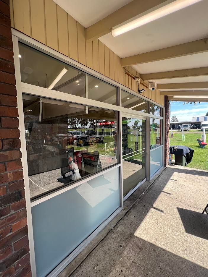 A Brick Building With A Glass Door And — Glass 24/7 In Taree, NSW