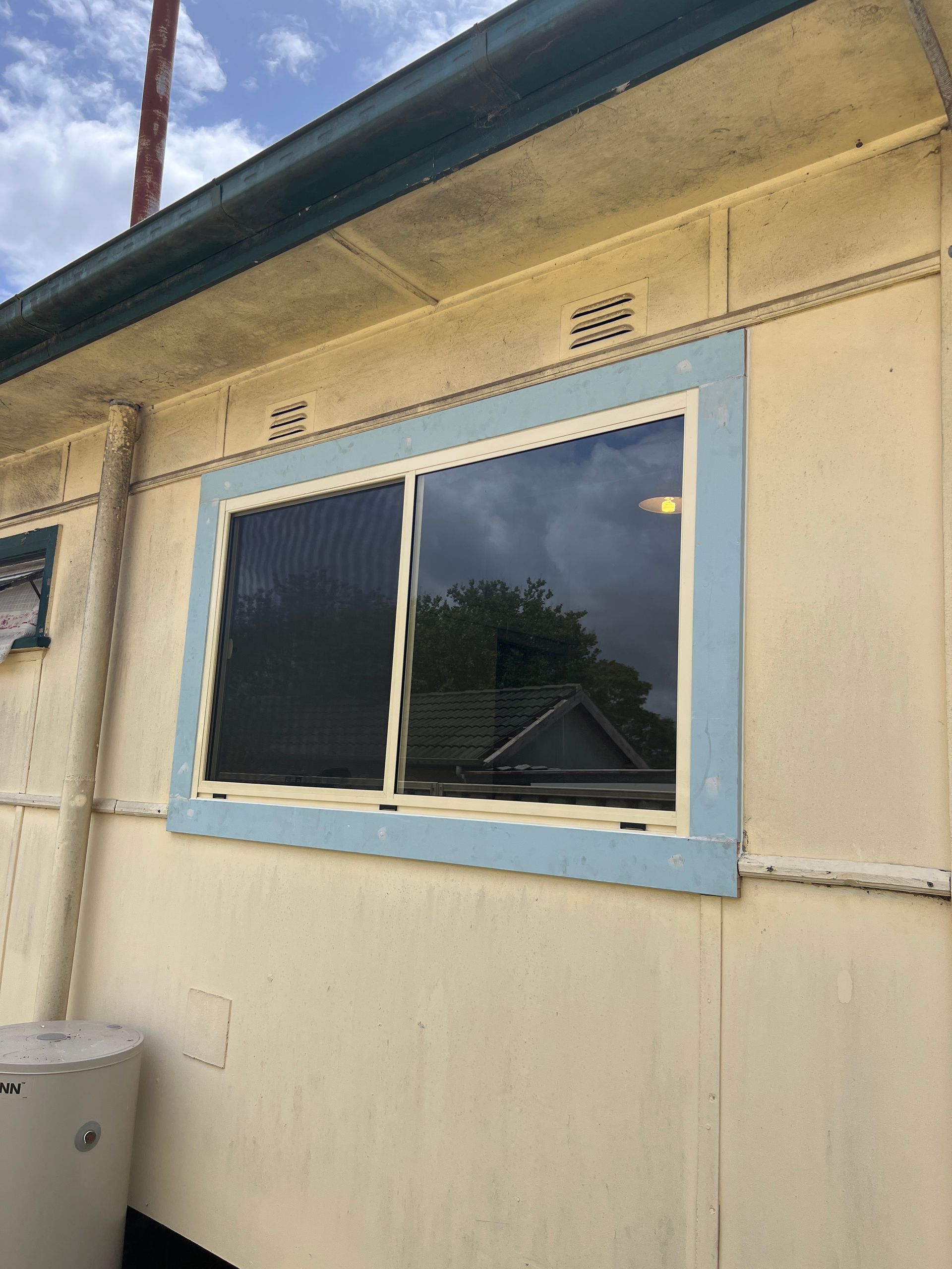 A yellow exterior of a building — Glass 24/7 In Taree, NSW