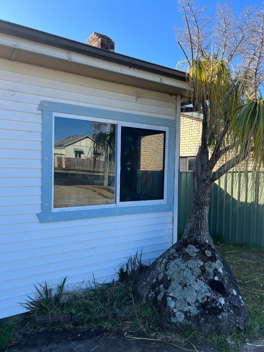 A White House With A Window And A Tree In Front Of It — Glass 24/7 In Taree, NSW