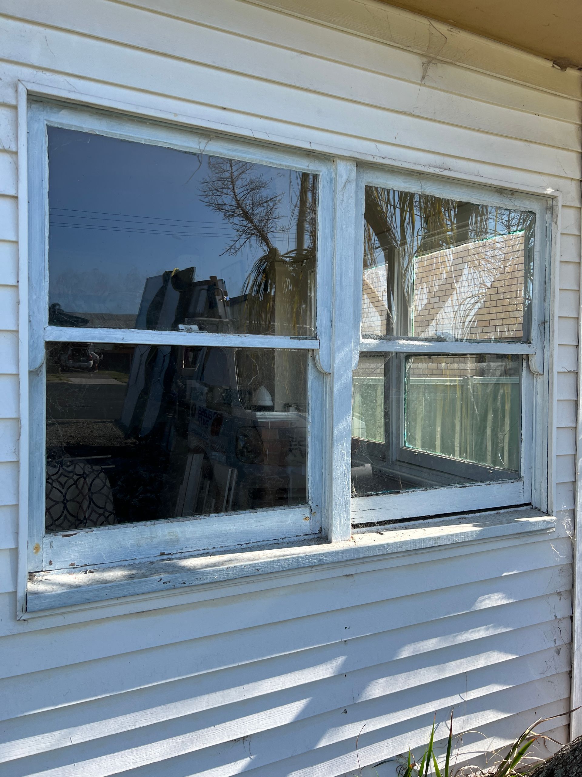 A white house with a broken window on the side of it — Glass 24/7 In Taree, NSW
