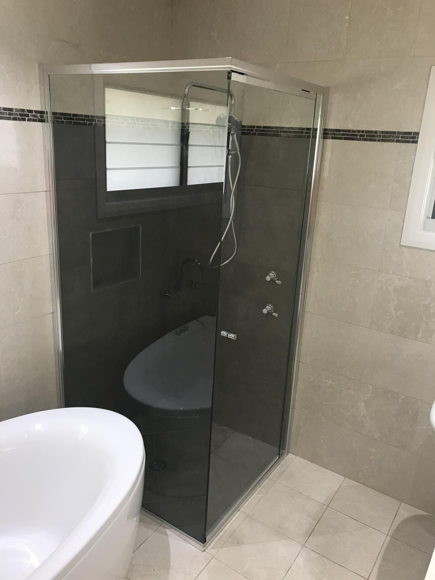 A Bathroom With A Bathtub, Toilet And Shower Stall — Glass 24/7 In Taree, NSW