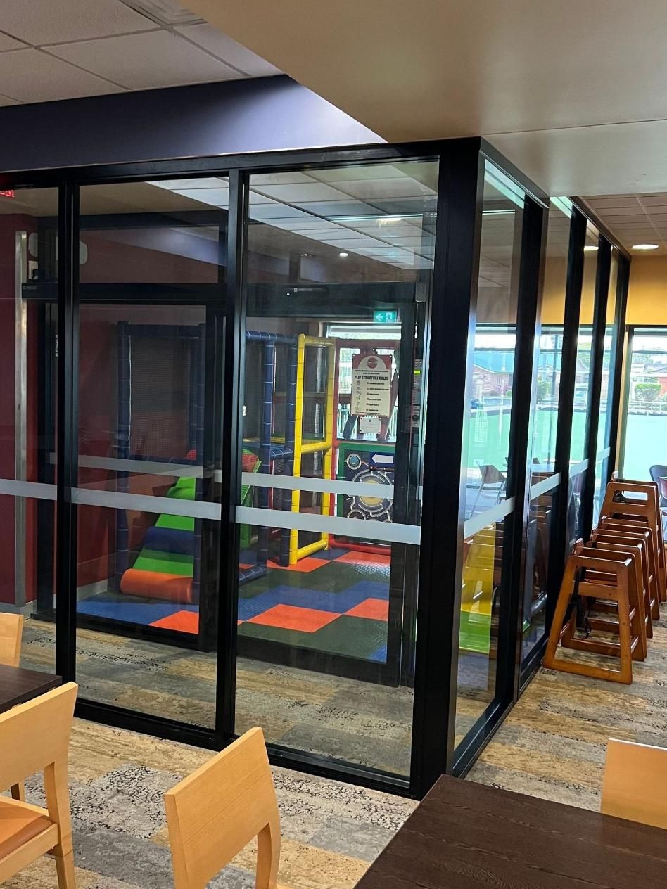 A Room With Tables And Chairs And A Playground In The Background — Glass 24/7 In Taree, NSW