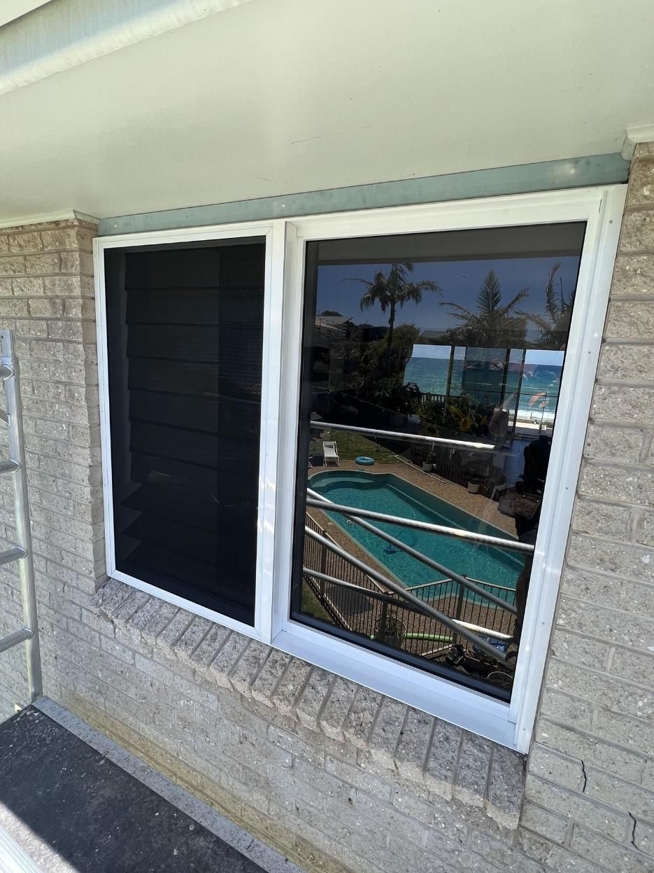 A Window On A Brick Building With A Pool In The Background — Glass 24/7 In Taree, NSW