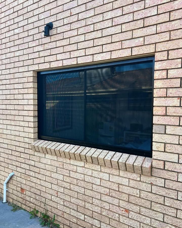 There Is A Window On The Side Of A Brick Building — Glass 24/7 In Hallidays Point, NSW
