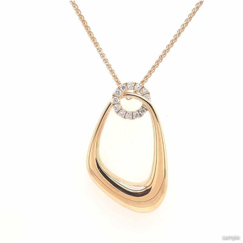 Gold pendant necklace with a diamond-studded ring and open, organic shape.