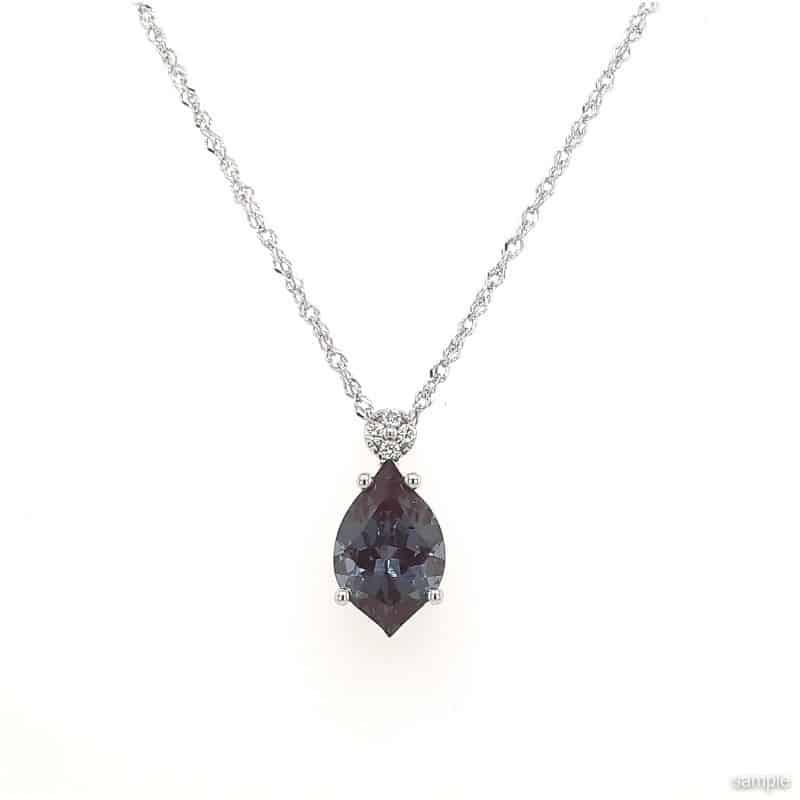 Silver necklace with a pear-shaped, color-changing Alexandrite pendant and small diamond accents.