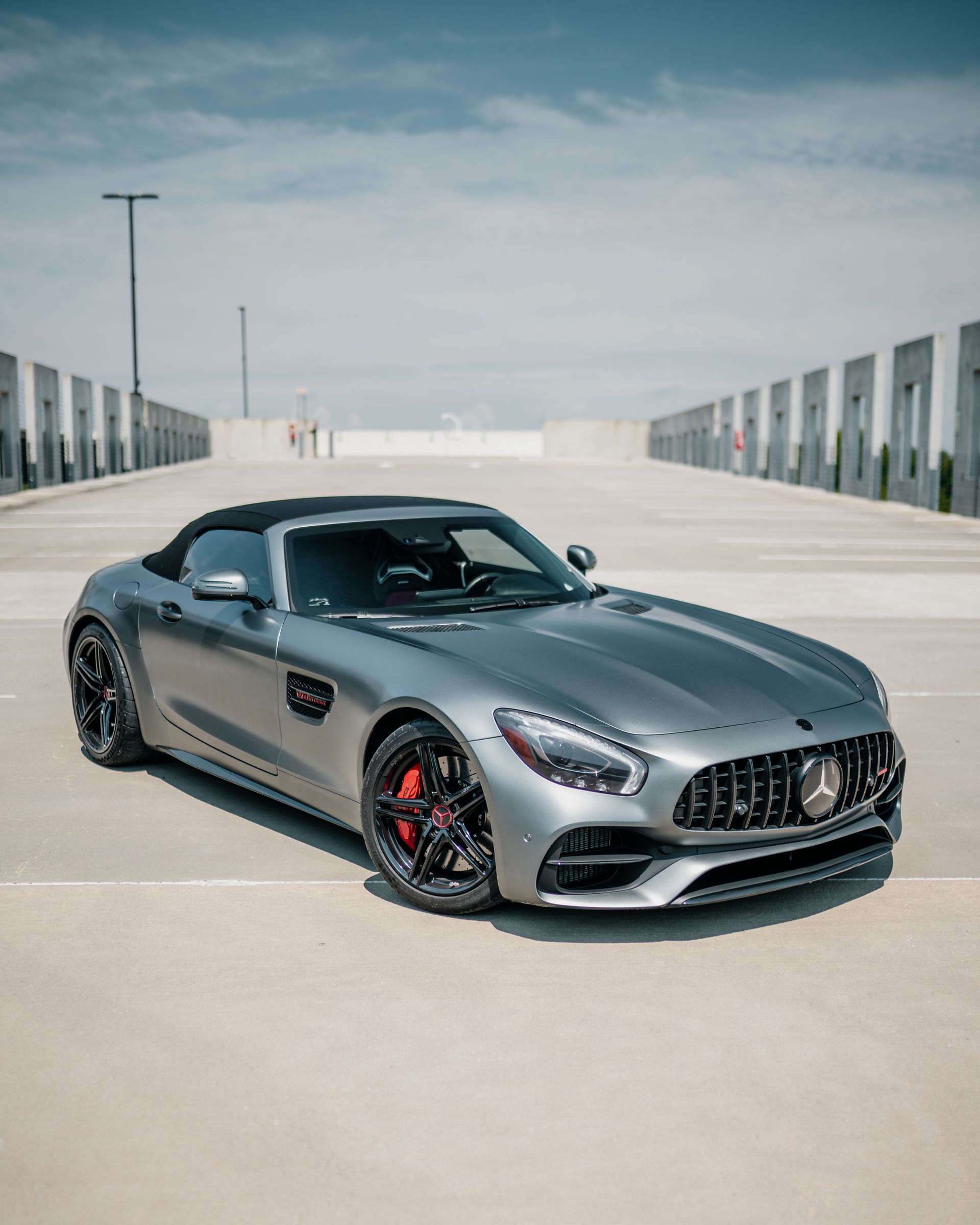 A mercedes amg gt convertible is parked in a parking lot.
