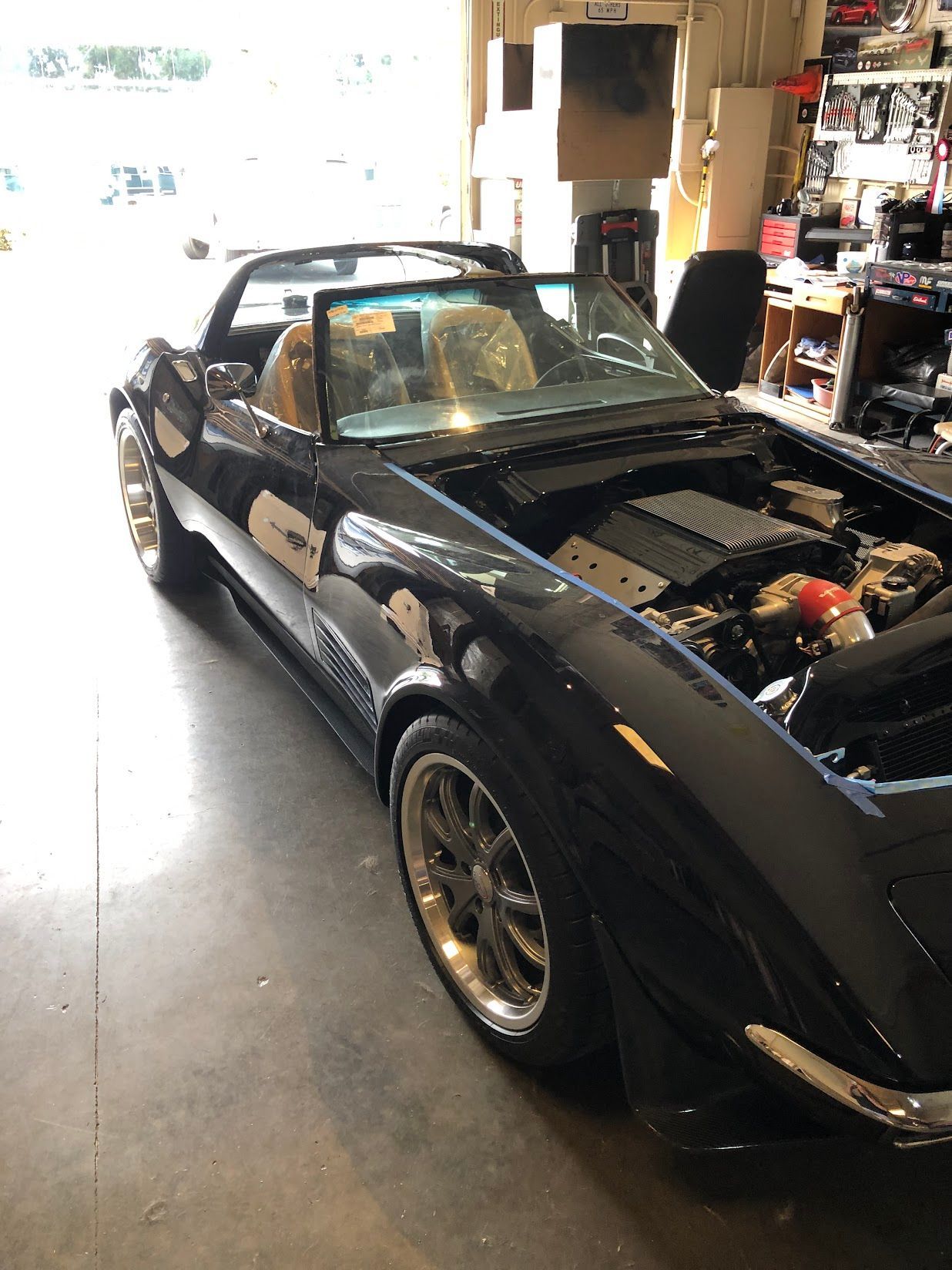 Auto glass shop interior with vehicle service and windshield calibration equipment