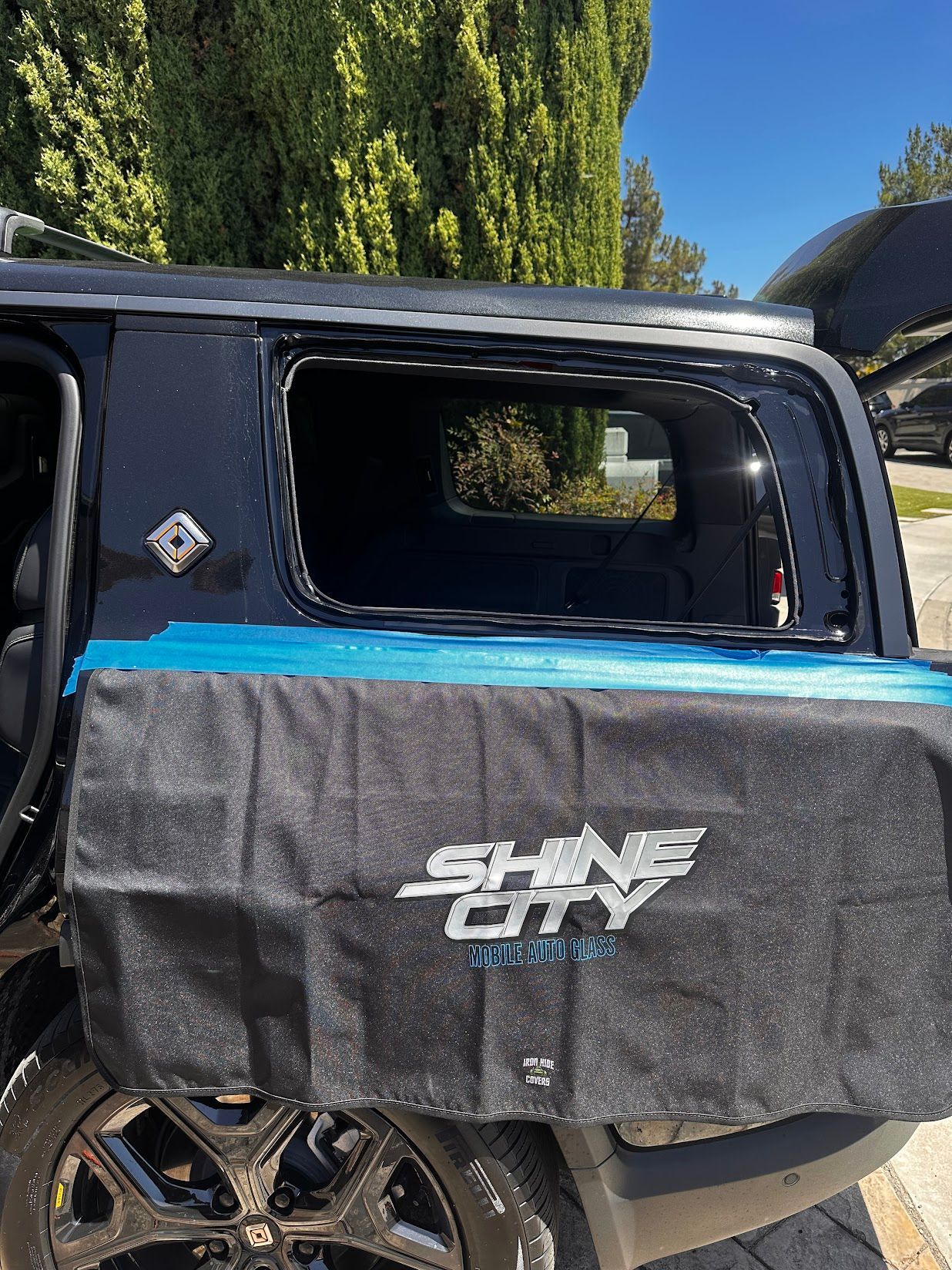 Shine City Auto Glass protective cover over a vehicle during auto glass service