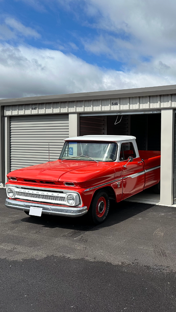 Classic red truck parked in a drive-up storage unit at Open City Self Storage in Elburn, IL.