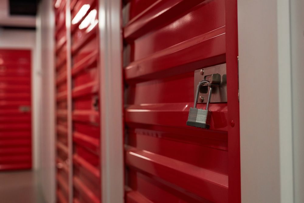 A row of red storage lockers with a padlock on the door.