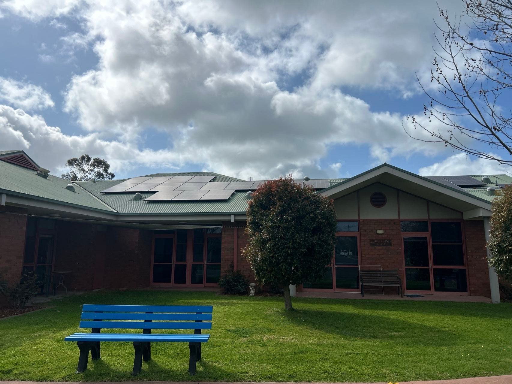 solar installation for grampians health on a green metal roof with brick building