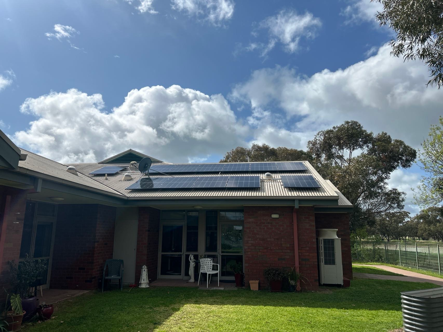 solar installation for grampians health on a cream metal roof with skylights and satellite dish