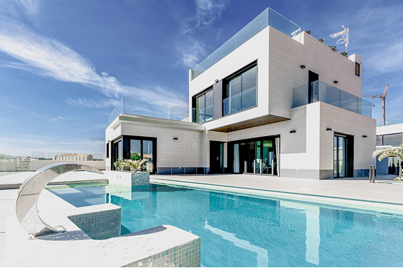 A modern, white two-story villa with a swimming pool and a waterfall feature under a bright blue sky.