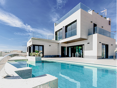 A modern, two-story white villa with a flat roof, large glass sliding doors, and a private swimming pool under a blue sky.