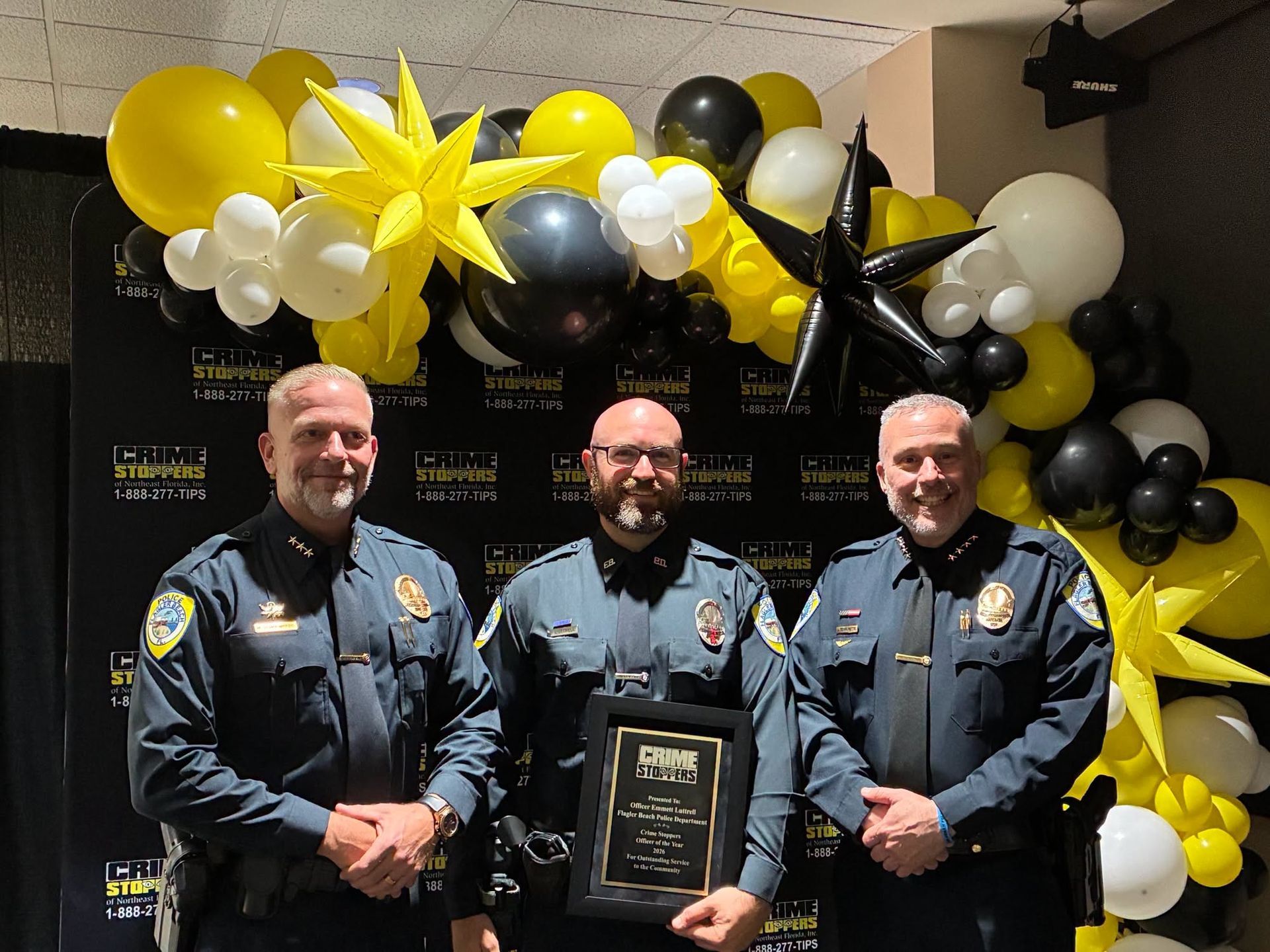 3 officers from FBPD standing at a crime stoppers event