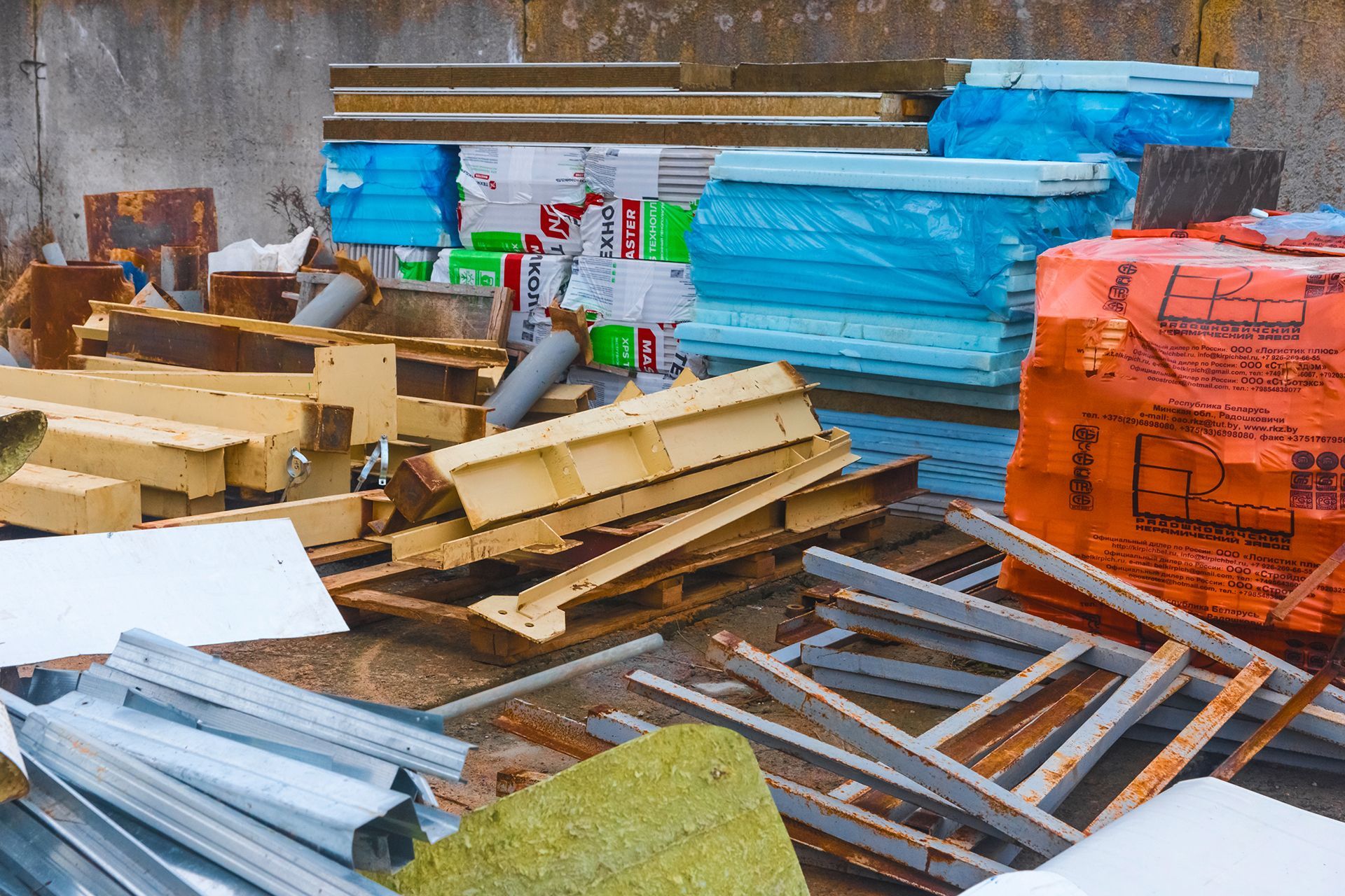 a pile of wood sitting next to a building