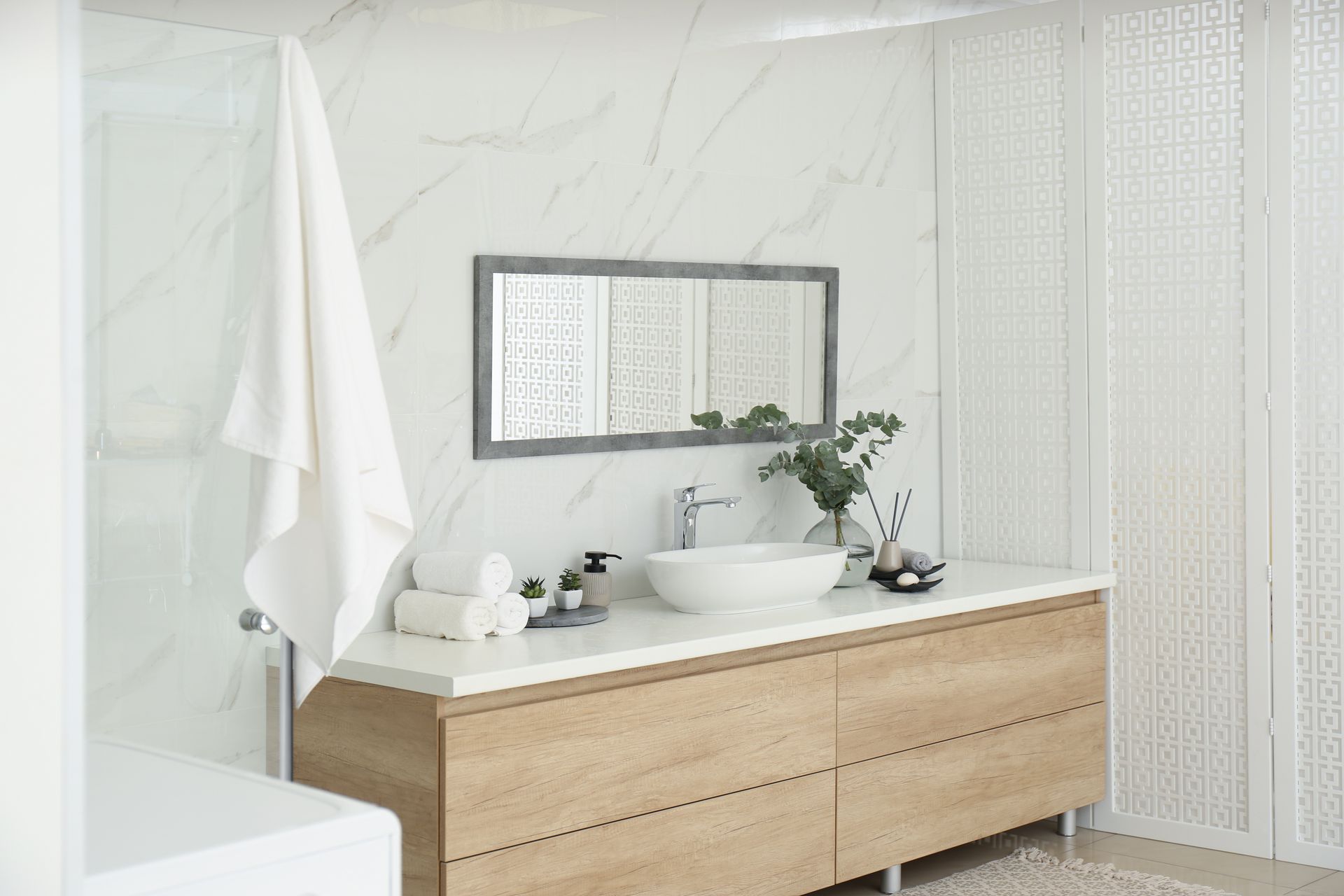 Bright Bathroom Vanity With White Sink, Mirror, Wood Cabinets, and a Shower Curtain — Hinch Plumbing In Breakwater, VIC