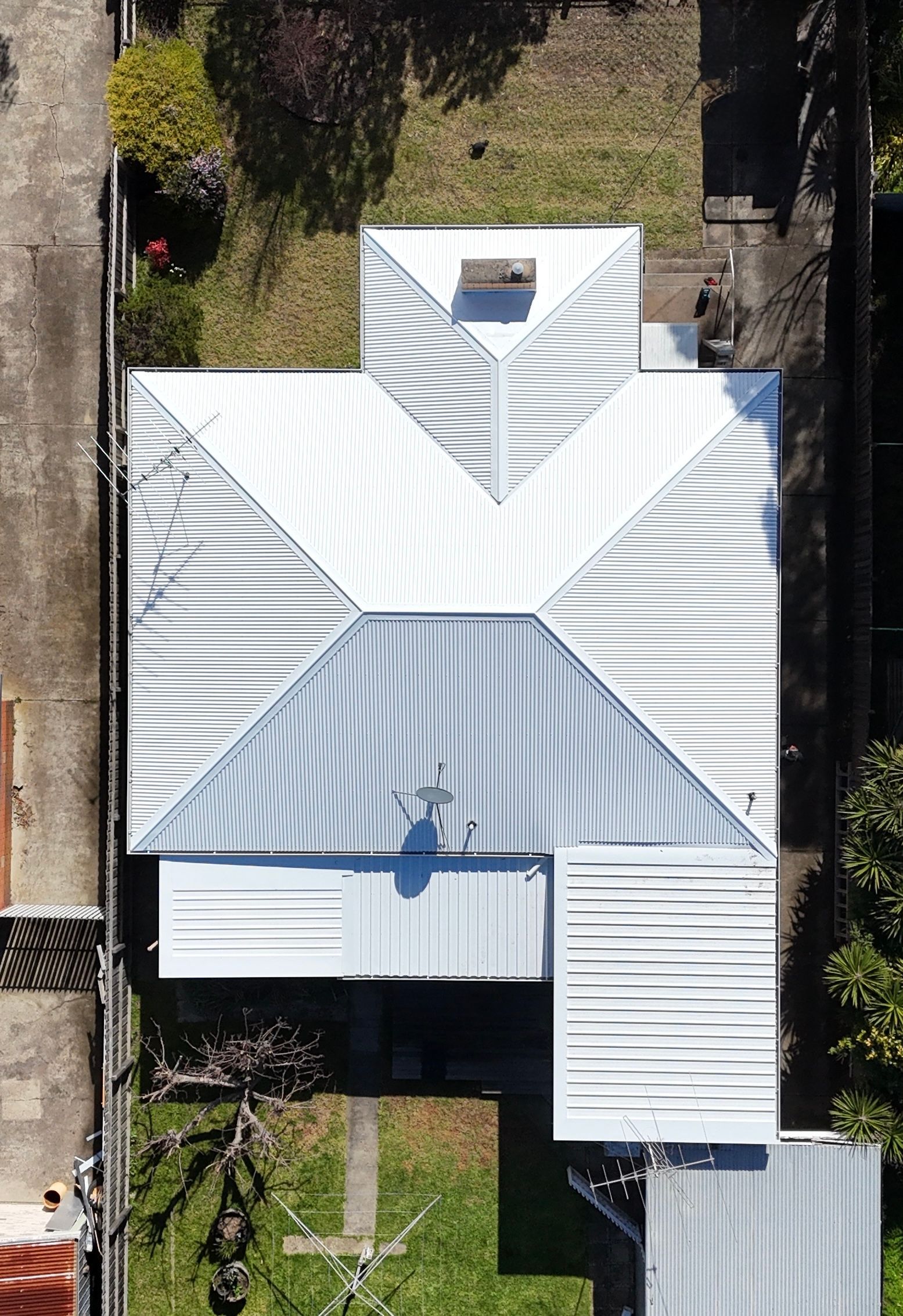 Aerial View of a White Metal-roofed House With Gray Accents and a Small Front Yard — Hinch Plumbing In Breakwater, VIC