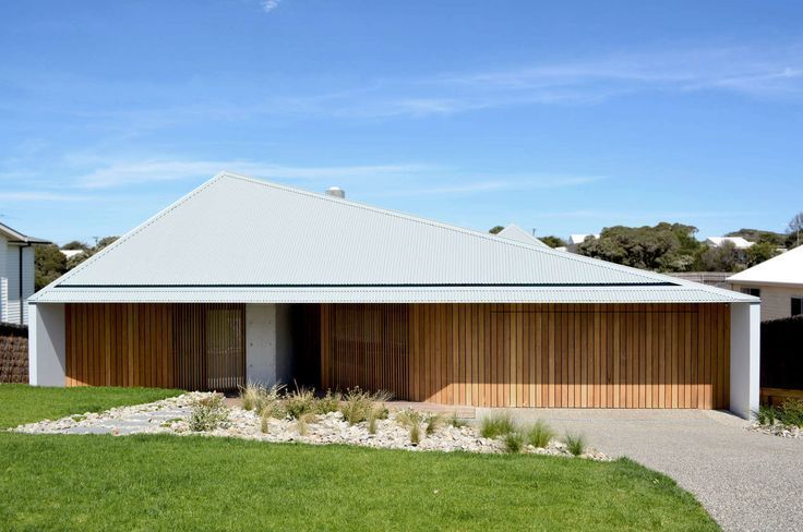 Modern Single-story House With White Roof, Wood Slat Facade, and Green Lawn — Hinch Plumbing In Breakwater, VIC