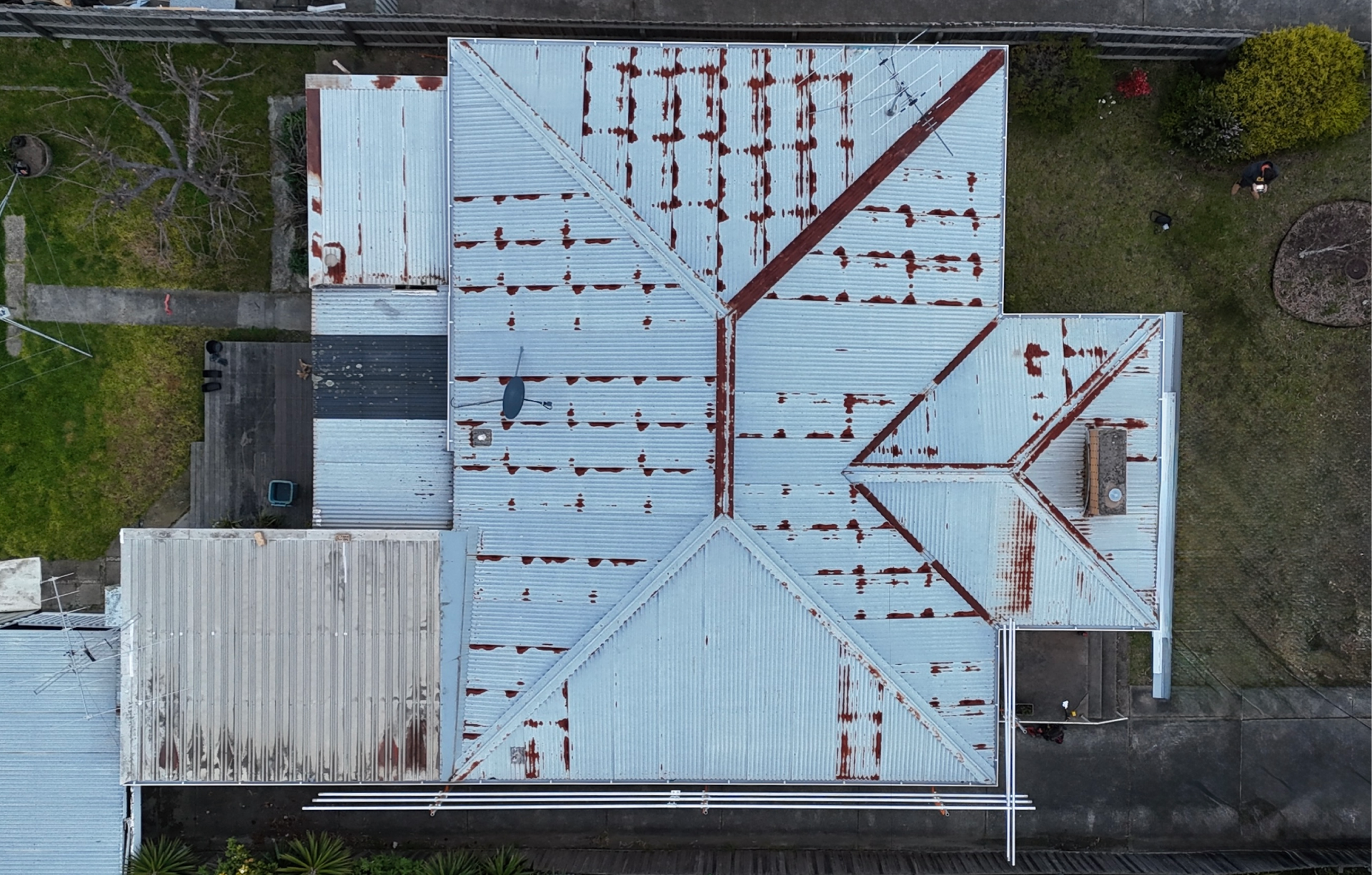 Weathered Metal-roofed Building With Rust-streaked Panels — Hinch Plumbing In Breakwater, VIC