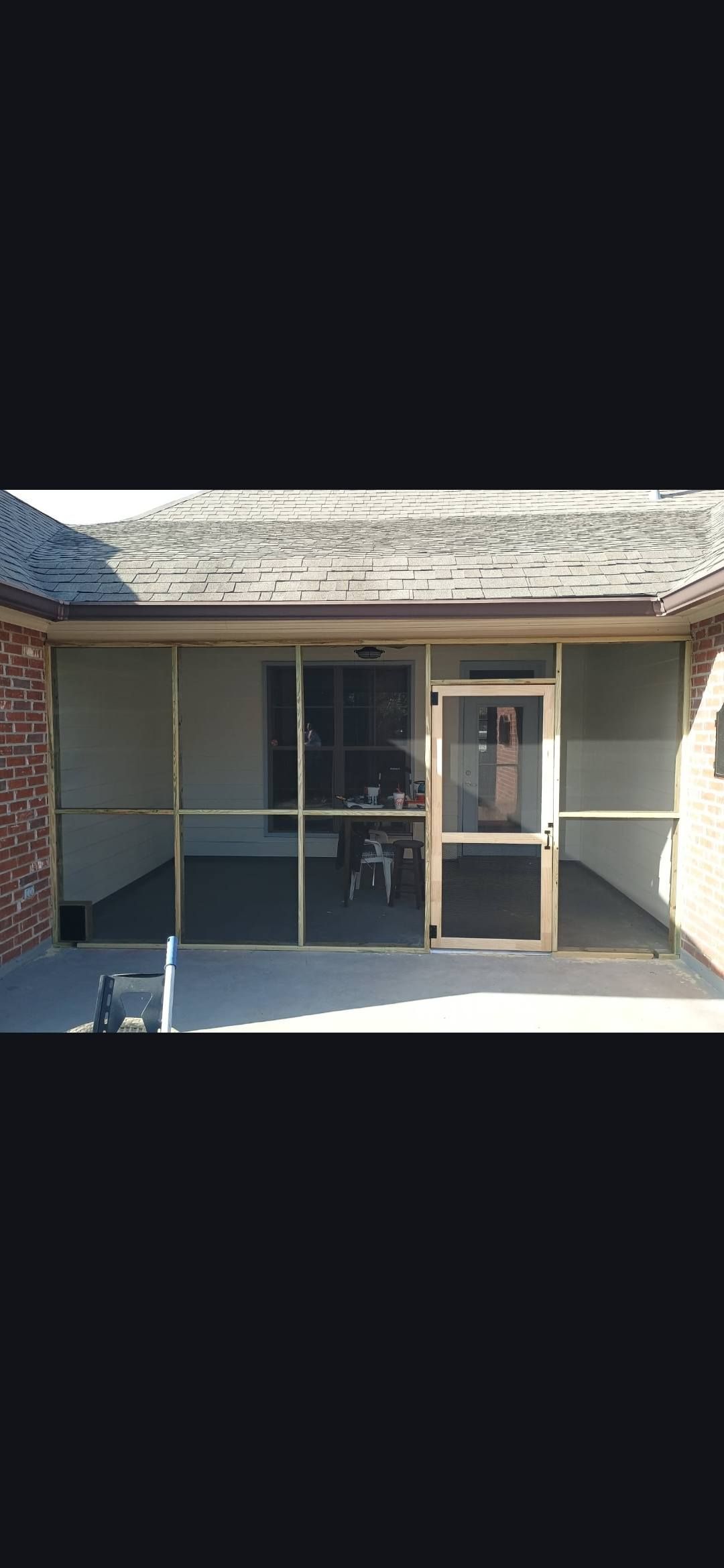 Front of a vacant storefront with a striped awning, glass door, and shaded sidewalk.