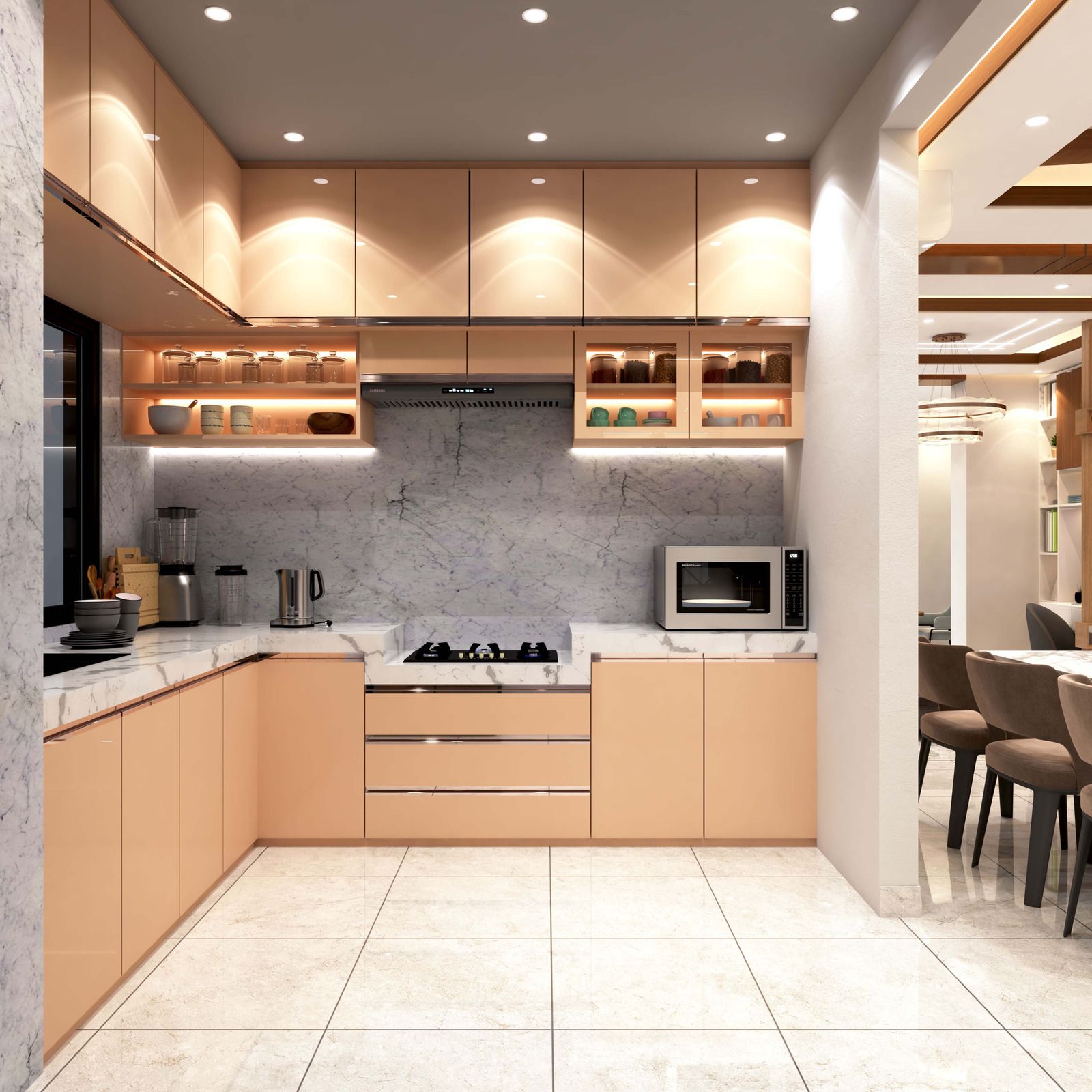 Modern kitchen with peach cabinetry, marble counters, built-in lighting, and a small dining area nearby