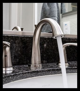 A bathroom sink with a faucet that says kohler on it