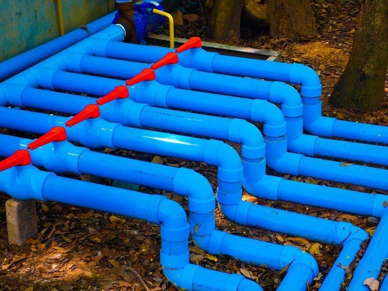A bunch of blue pipes of water lines.