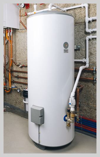 A white water heater is in a room with pipes