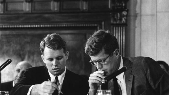 John F. Kennedy and Robert F. Kennedy at a congressional hearing, illustrating a discussion of nepotism in public office.